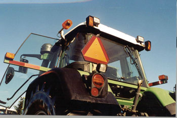 Machinery travelling slower than 40 km/h must have a slow moving vehicle sign attached to the back of the self-propelled farm equipment and any towed implement.